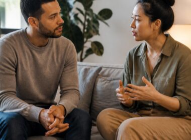 Two adults sit together and cautiously build trust while maintaining personal space.